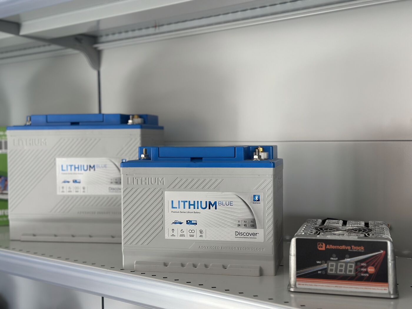 ALT charger paired with a partner battery on the showroom shelf
